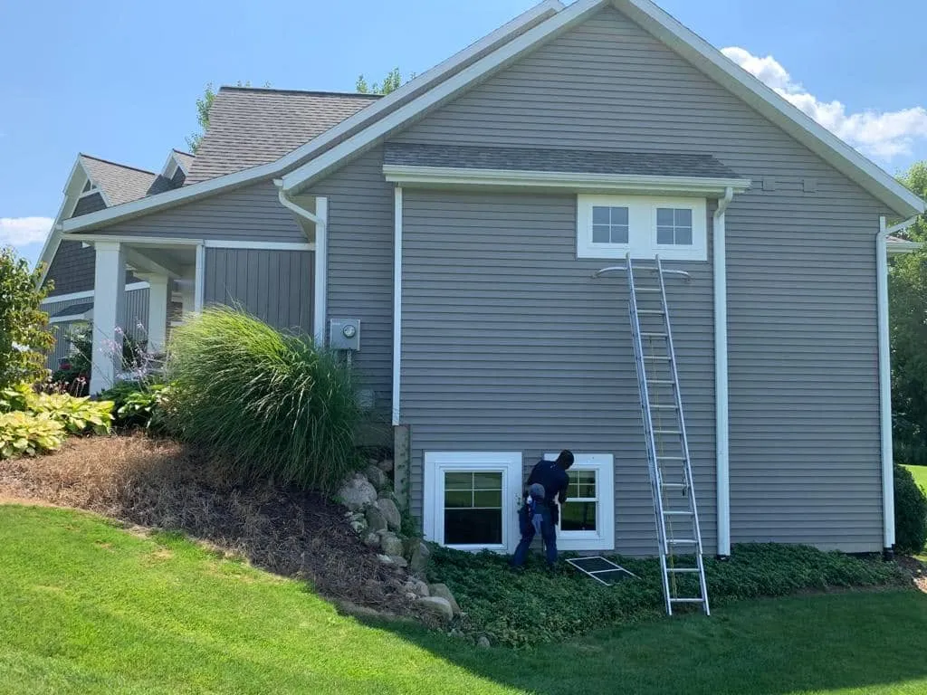 Professional cleaning of vinyl siding on a residential home